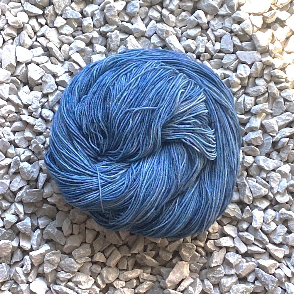 Photo of a skein of BFL/Nylon hand-dyed in 'Stormy Sky' rolled into a solid circle