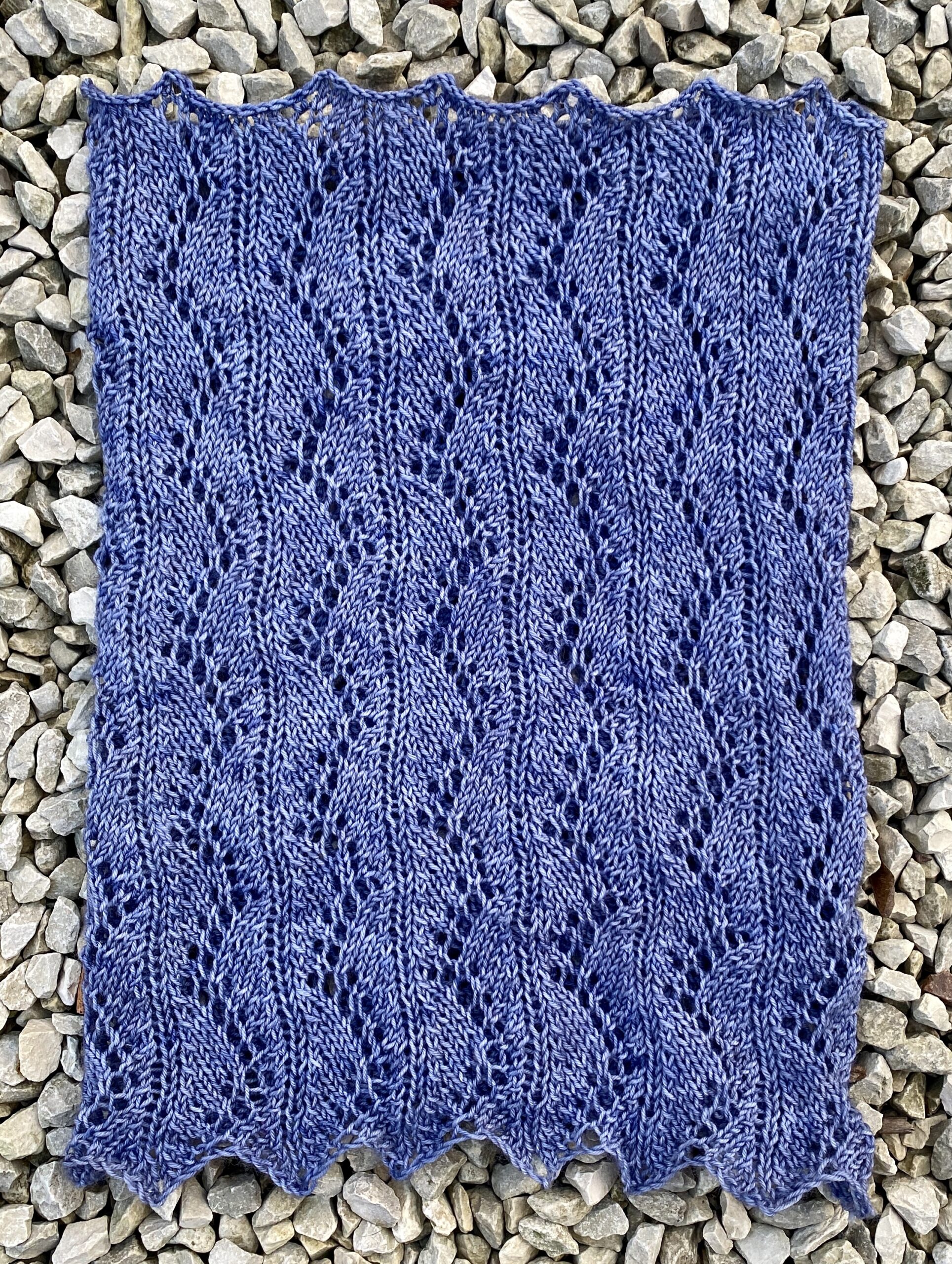 Cowl knitted in a blue toned grey, laid flat