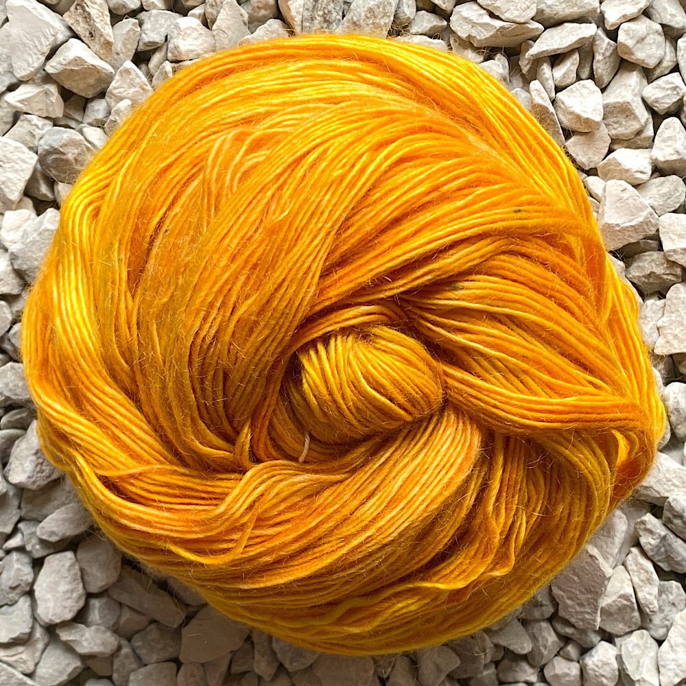 a swirl of merino/mohair yarn in 'mellow' - a mix of light to deep mustard toned yellows