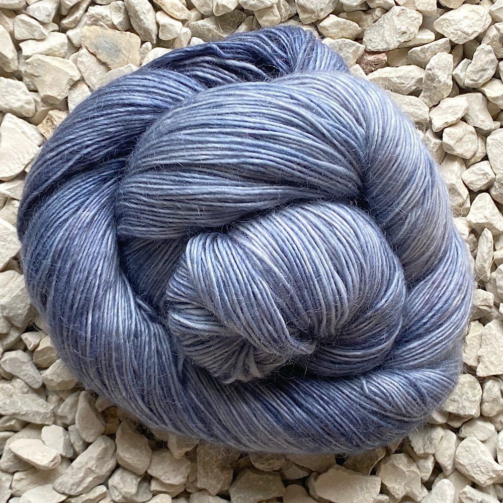Rolled skein of merino/mohair in 'Slate', a mix of light to deeper greys