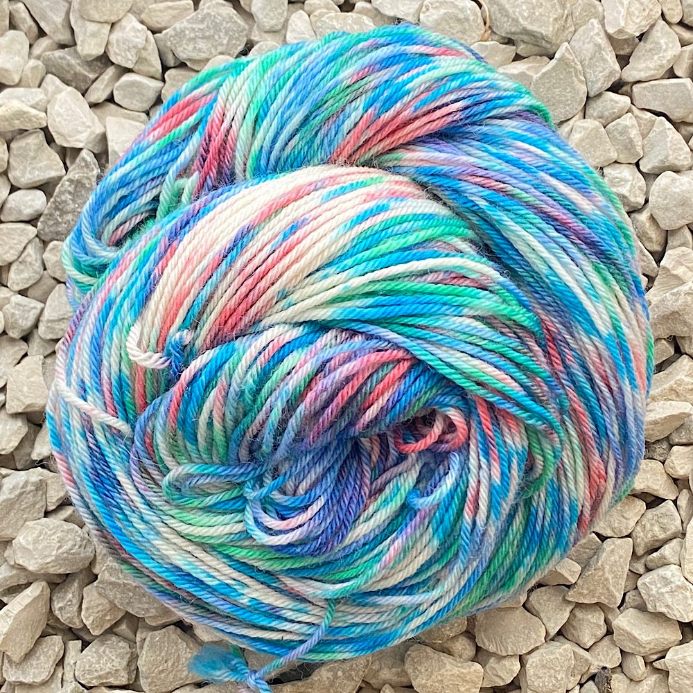 Swirl of DK wool in the cartoon colours of Angouleme.