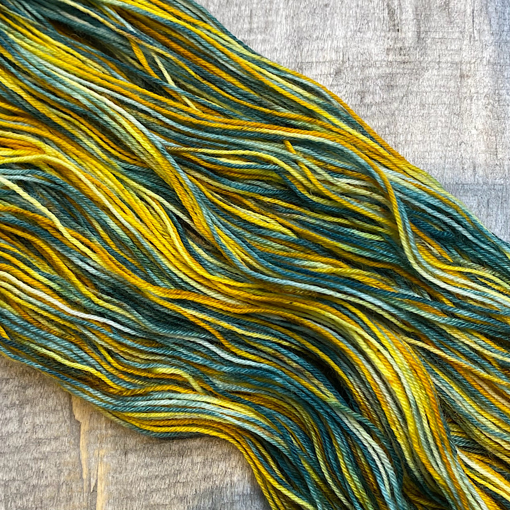 Photograph of hand dyed BFL wool in 'Trent Bridge, arranged flat and spread out. The colours are taken from the actual Trent Bridge in Nottingham, in England.