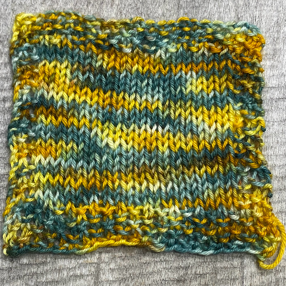 Photograph of a knitted square using the hand dyed BFL wool in 'Trent Bridge. it shows the general look of this dye style.