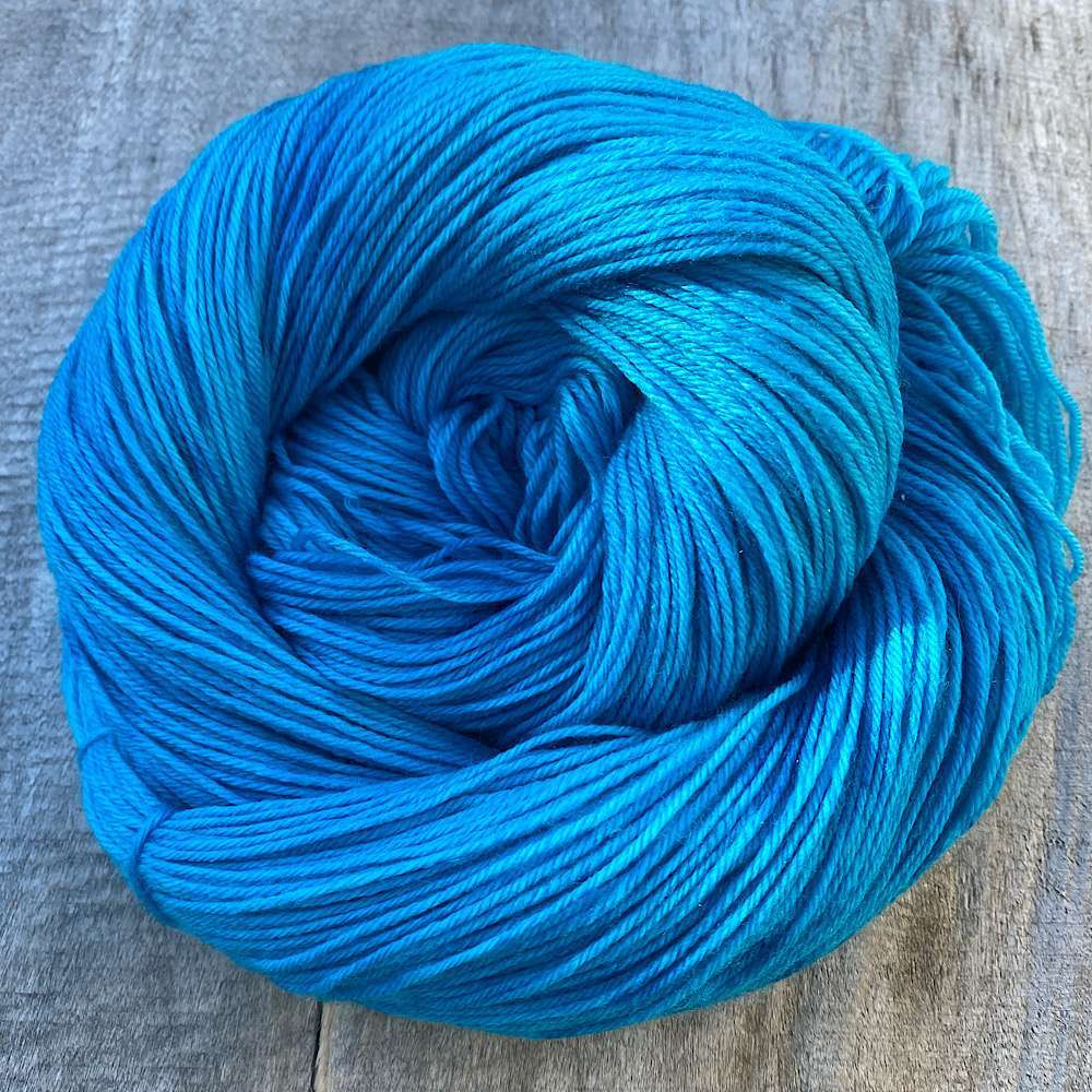 A swirled skein of MCN wool in 'Luxe sky' - adeep, summery blue