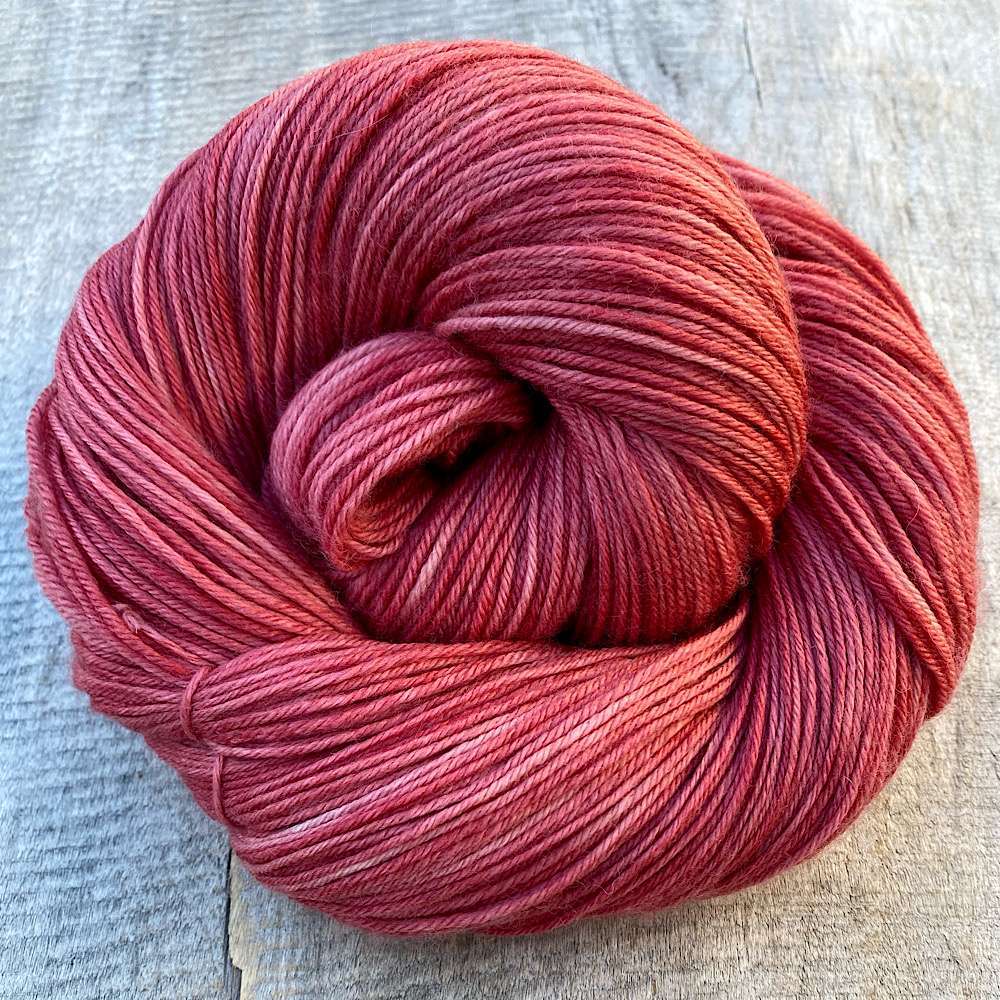 A swirl of hand dyed MCN yarn in a subtle range of warm brown,-toned, dusty pinks