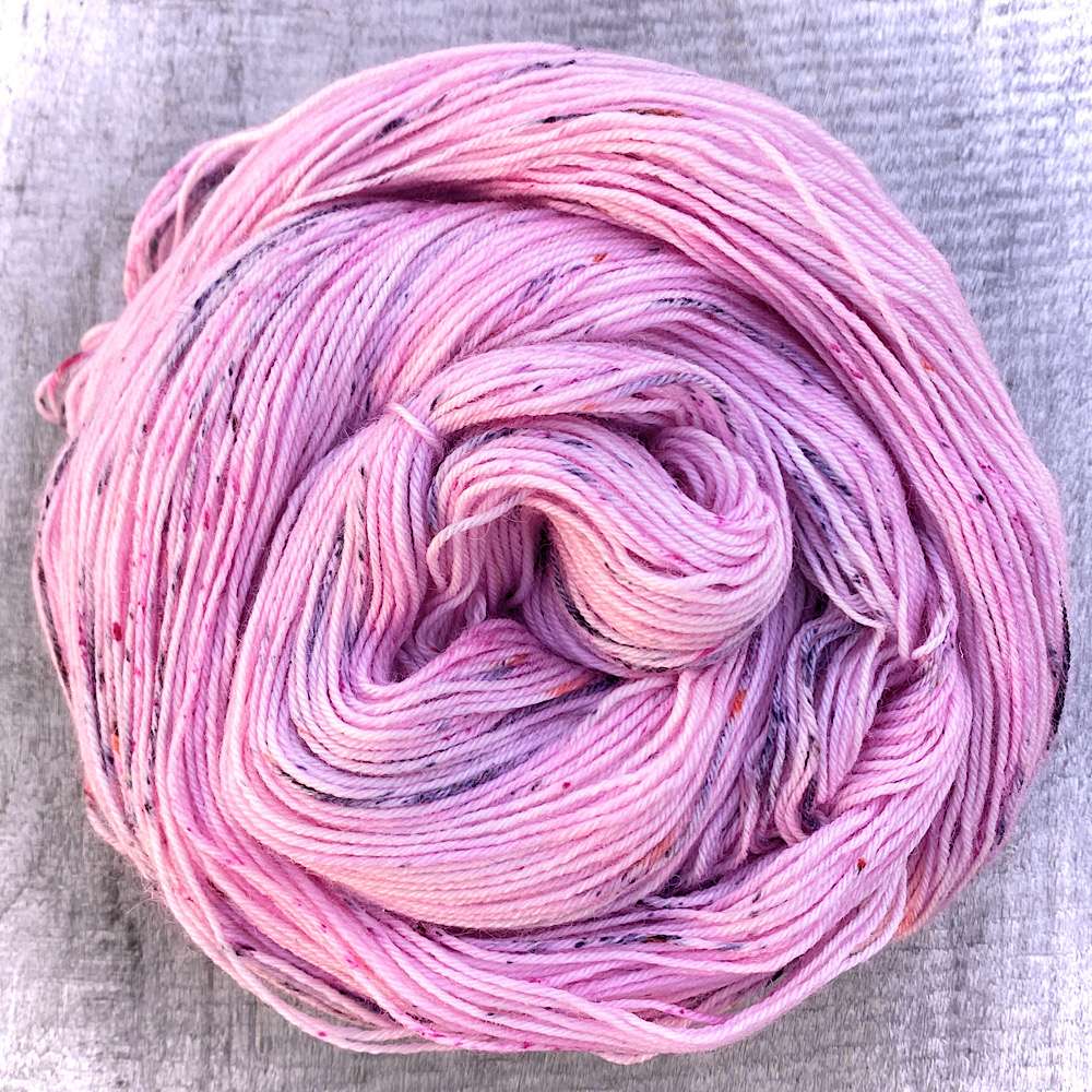 a Swirl of handdyed yarn called Pink Hibiscus, in pink with grey speckles